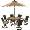 Hanover Monaco 7 pc. Dining Set with 6 Wicker Back Swivel Rockers, 60 in. Table, 9 ft. Umbrella, Tan, MONDNWB7PCSW6RDTL-SU-T -Hanover Sales 1715082